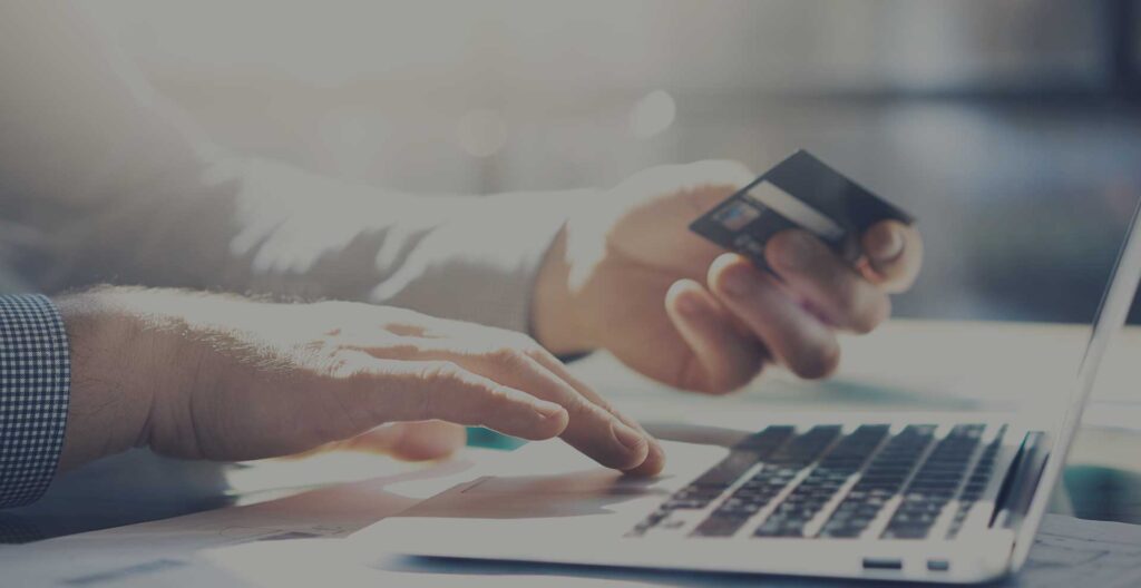 man with credit card and computer